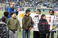 Yesler kids display goal post designs at Sounders game halftime