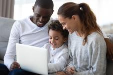 Family looking at laptop