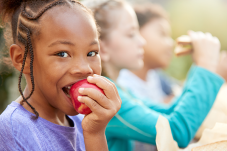 Stock photo of girl eating an apple