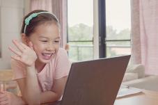 Child waving a laptop