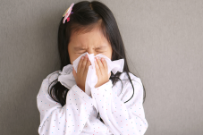 Young girl sneezing