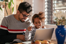 Father and child looking at computer screen