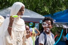 Children playing with bubbles at 2022 NewHolly Family Fun Day
