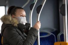 Woman wearing face mask on public transit