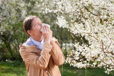 Stock photo of woman sneezing