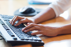 Person typing on keyboard