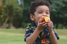 Stock image of child eating an apple
