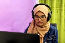 Woman with headphone working at a computer
