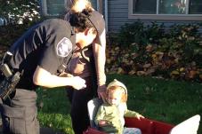 Community police officer talking to woman and child at Rainier Vista