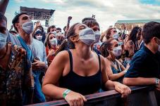 Crowd of people wearing face covering outdoors