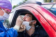 Man in car receiving drive-through Covid-19 test 