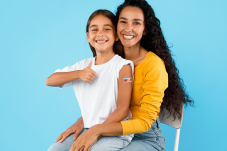 Image of mom and daughter against blue background