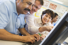 Image of people getting help with computer