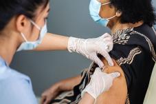 Elderly woman receiving injection