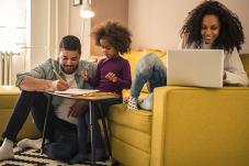 Family using computers in living room