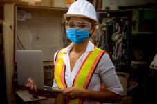 Female construction woriker wearing face covering