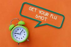Clock with text of 'Get your flu shot'