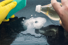 Image of a person cleaning with household products