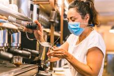 Woman making an espresso 