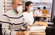 People sitting in library with face masks on
