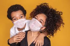 Mother and son wearing face covering