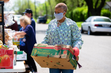 Image of woman carrying produce