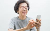 Elderly woman texting on phone
