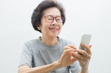 Elderly woman texting on phone