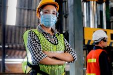 Woman in construction gear wearing face covering