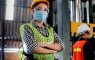 Woman in construction gear wearing face covering
