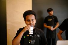 Teenage boy sips coffee