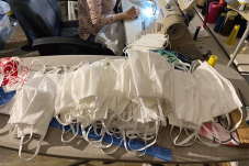 Stack of sewn cloth face masks on table
