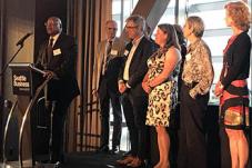 Adults standing near podium