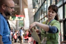 Woman reviewing a notepad with man standing nearby