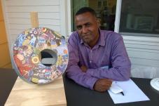 Man next to mosaic art