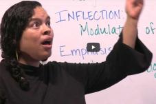 Woman in front of white board with text about 'infection modulation'