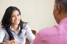 Woman at desk talking to man