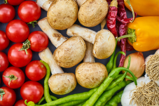 Tomatoes, mushrooms, peppers and bean in vegetable stand