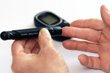 Hands hold glucose meter