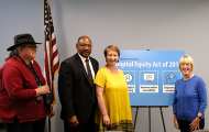 Senator Patty Murray with SHA Executive Director Andrew Lofton and residents with "Digital Equity Act of 2019" panel behind them