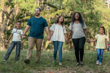 Adults and children walking hand in hand
