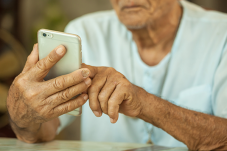 Elderly man using smart phone