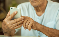 Elderly man using smart phone