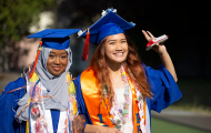 Two young women graduates in caps and gowns