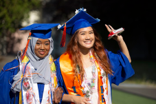 Two young women graduates in caps and gowns