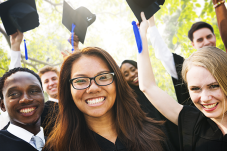 Group of young people wearing caps and gowns