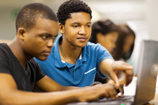 Two boys using laptop computer
