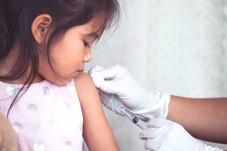 little girl getting an injection in arm