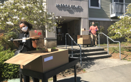SHA staff members deliver packaged meals to residential building