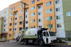 Truck with Seattle Housing Authority logo on it parked in front of apartment building
